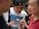 A group of friends enjoying mobile games together outdoors.