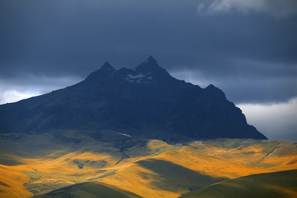 black mountain under gray clouds