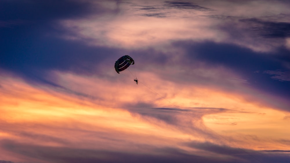 person paragliding in air during day time
