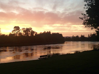 A quiet moment of reflection by a riverbank at sunset, where tradition meets nature’s calm.