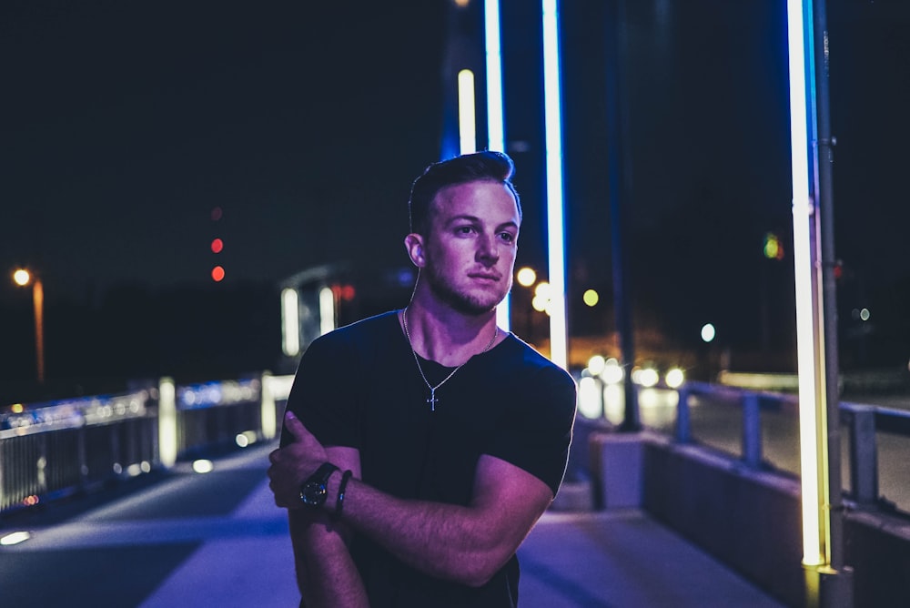 standing man wearing black t-shirt