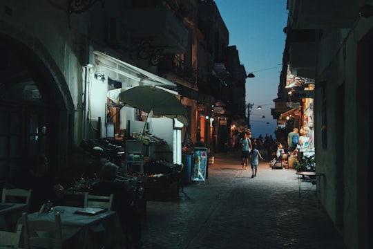 person walking near fruit lot at nighttime in Chania Greece