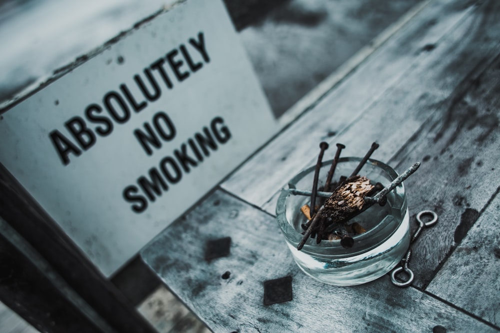 clear glass ashtray in bokeh photography