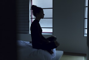 woman sitting on bed