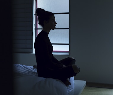 woman sitting on bed