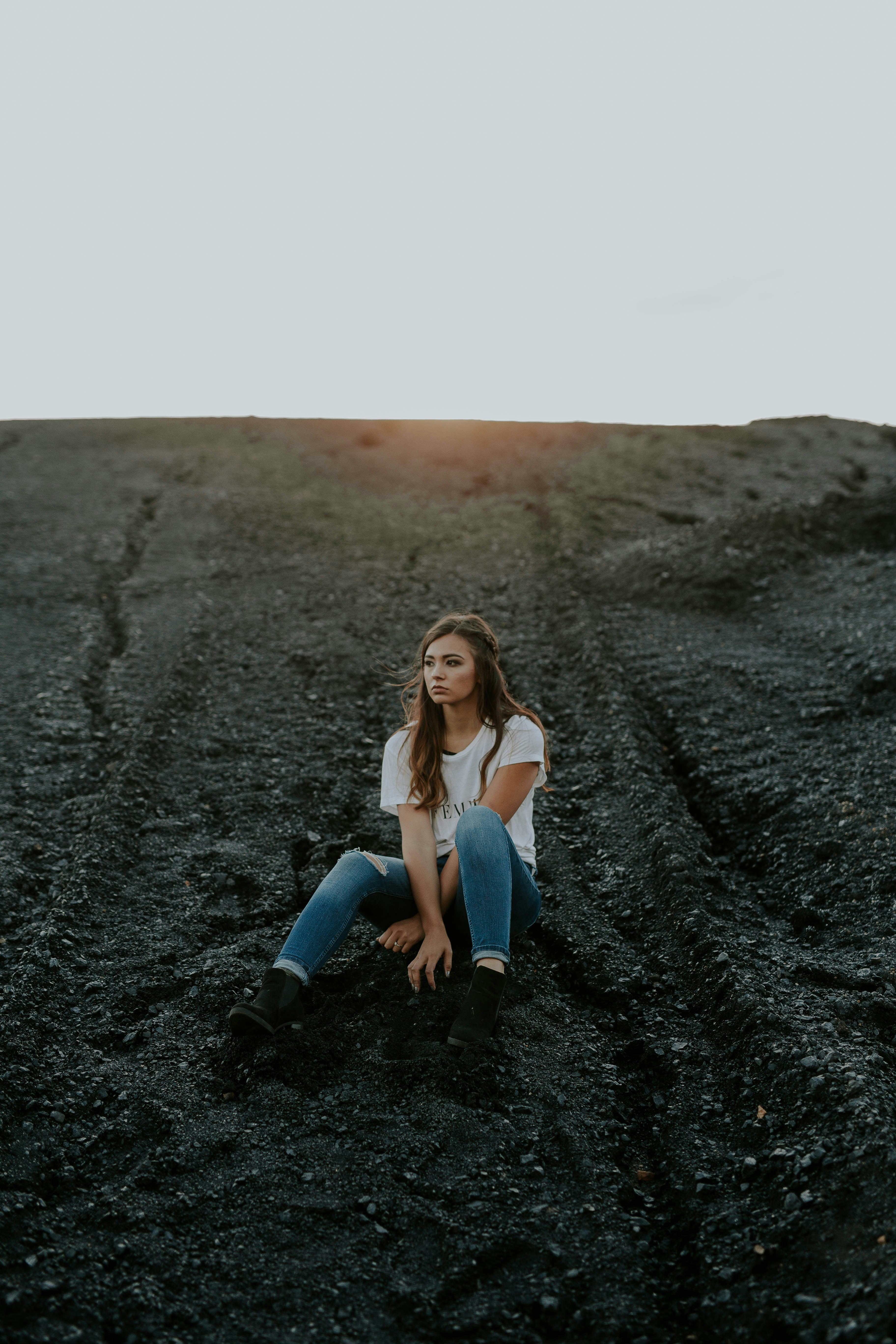 woman sitting on sand