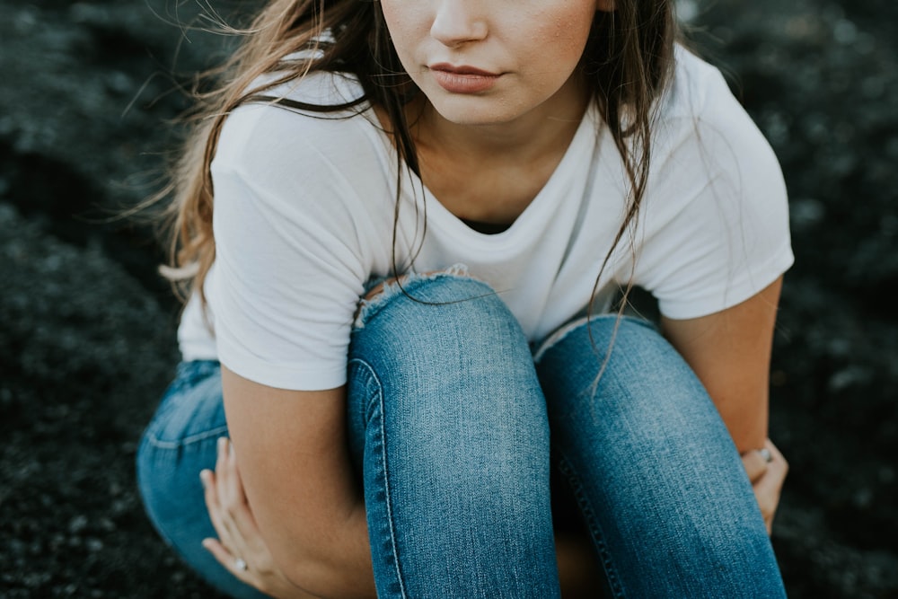 shallow focus photo of person in white scoop-neck T-shirt