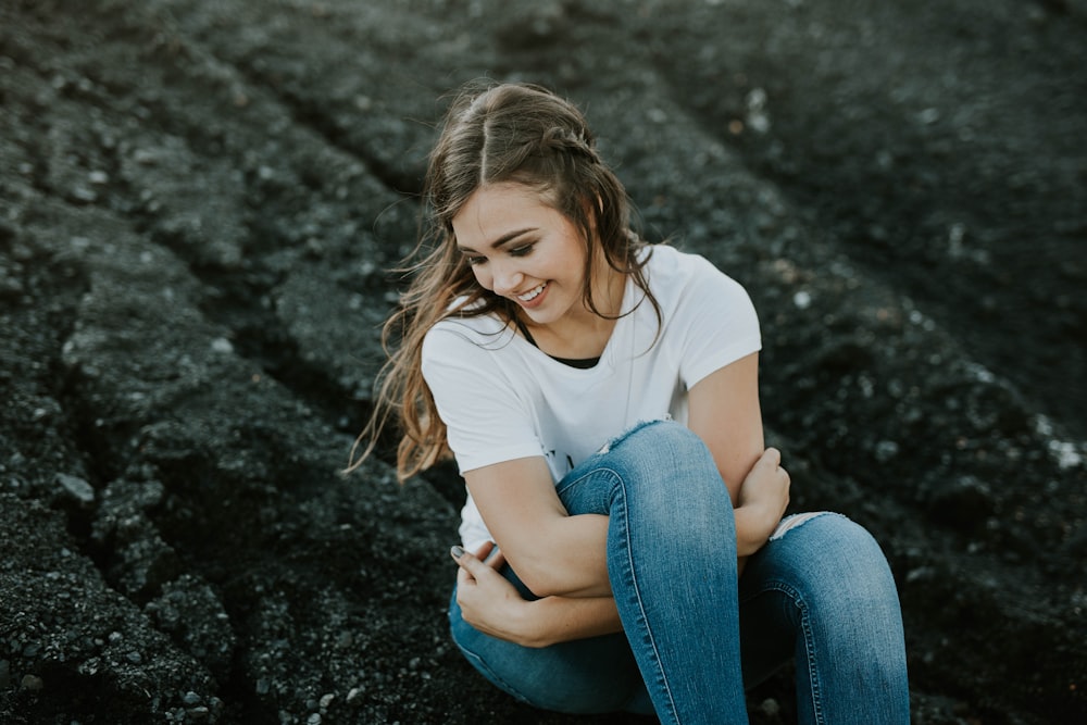 woman sitting on black soil during daytime