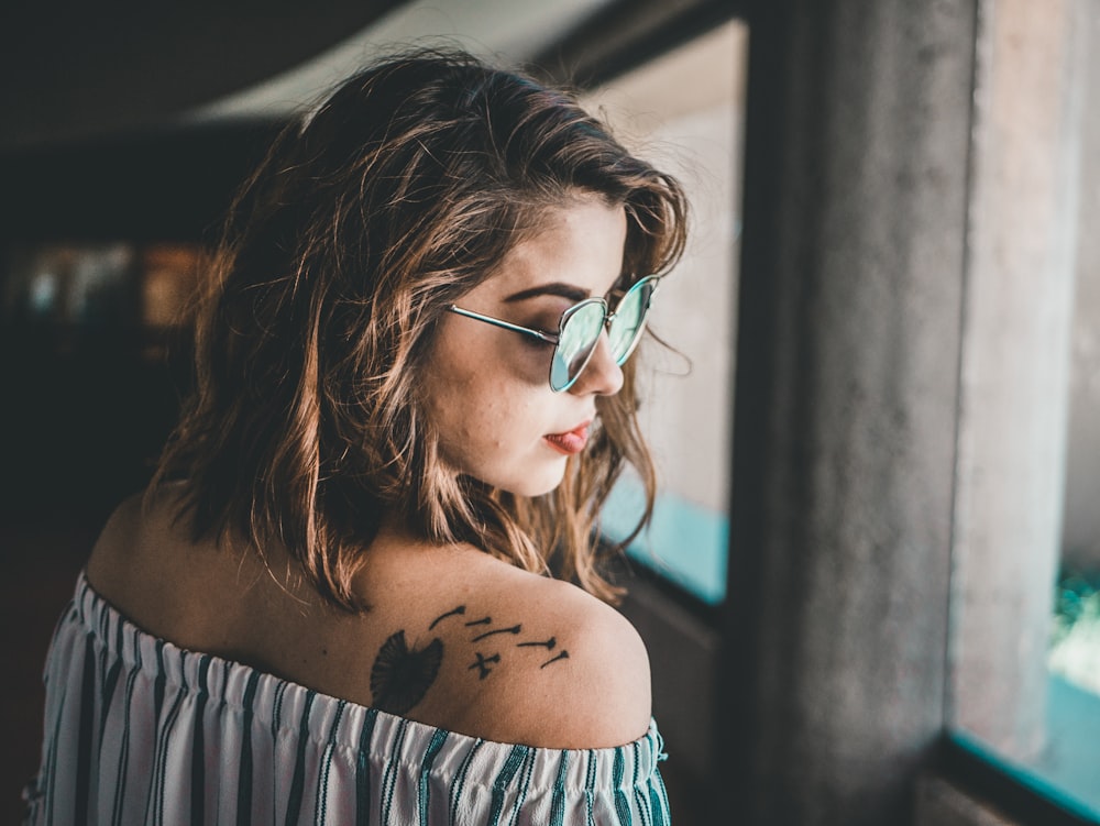 woman showing shoulder tattoo