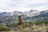 Hiker standing on a rocky peak overlooking the Caucasus mountains