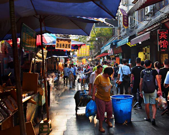 A colorful street market in Yunnan bustling with locals and vibrant stalls.