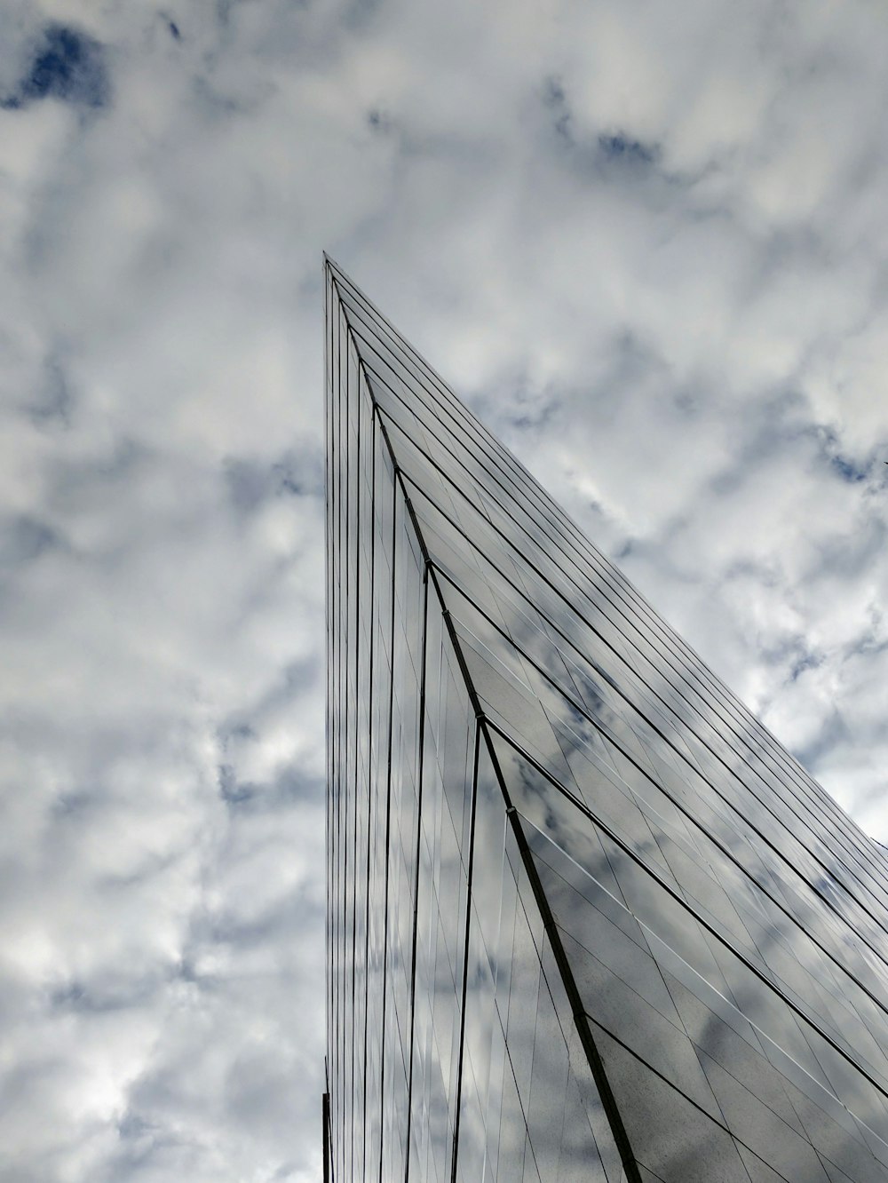 mirror building under white clouds and blue sky
