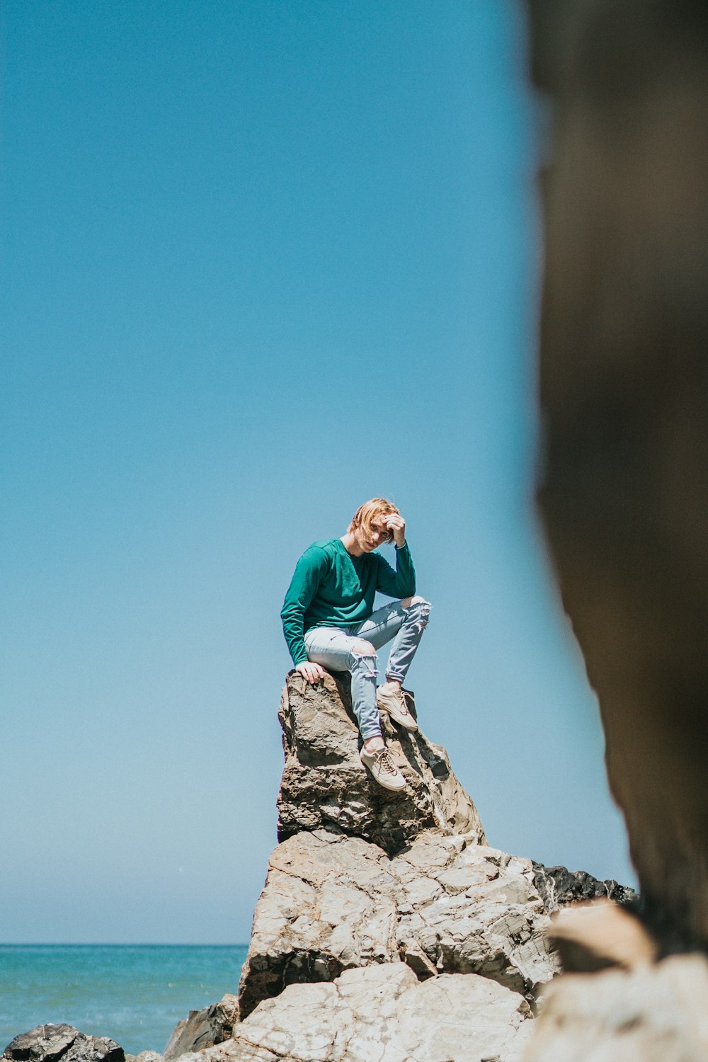 man wearing teal sweater