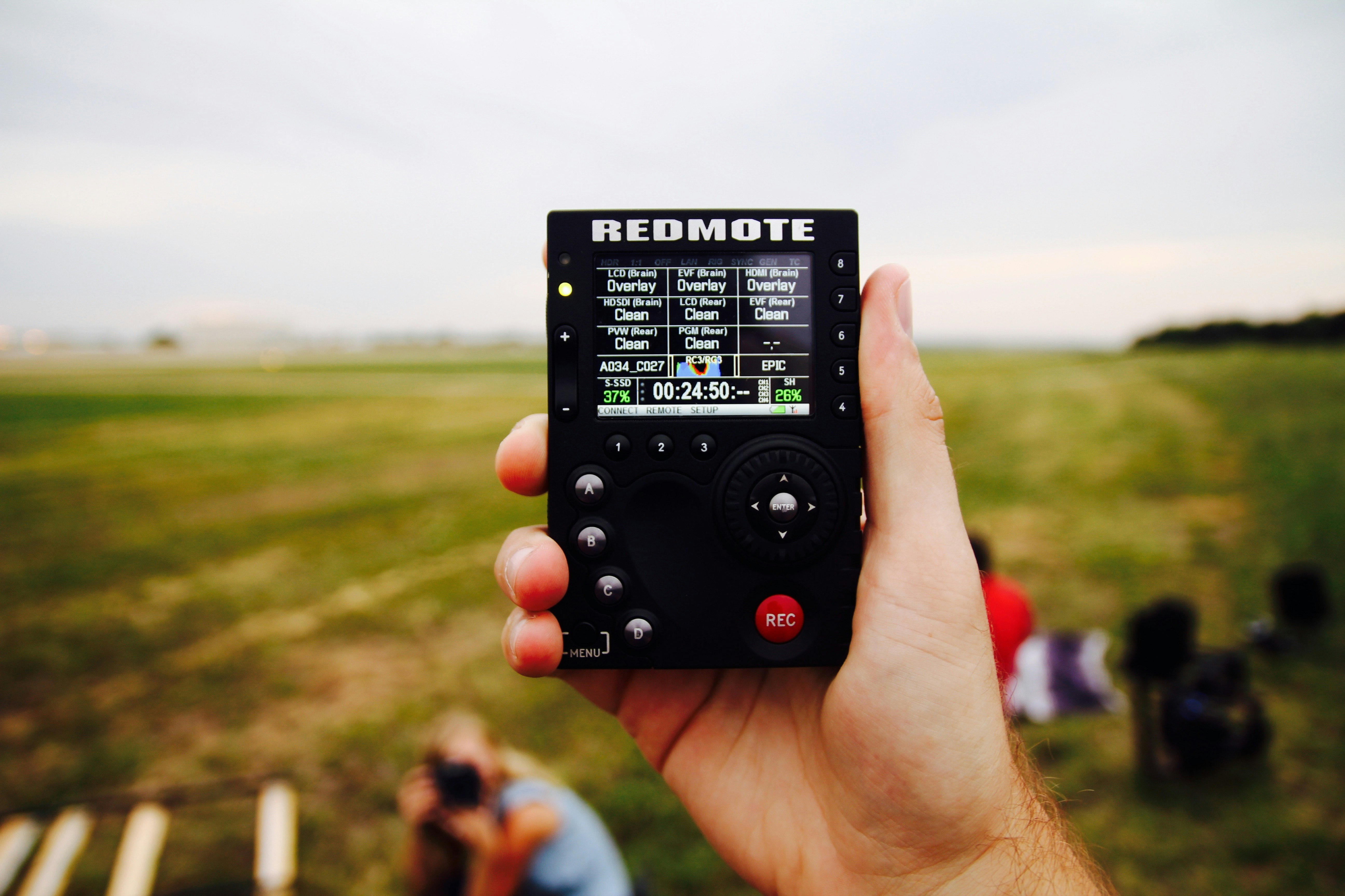 person holding Redmote digital device