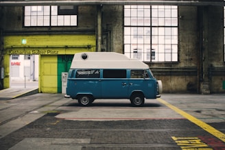 blue and white van inside yellow painted warehouse