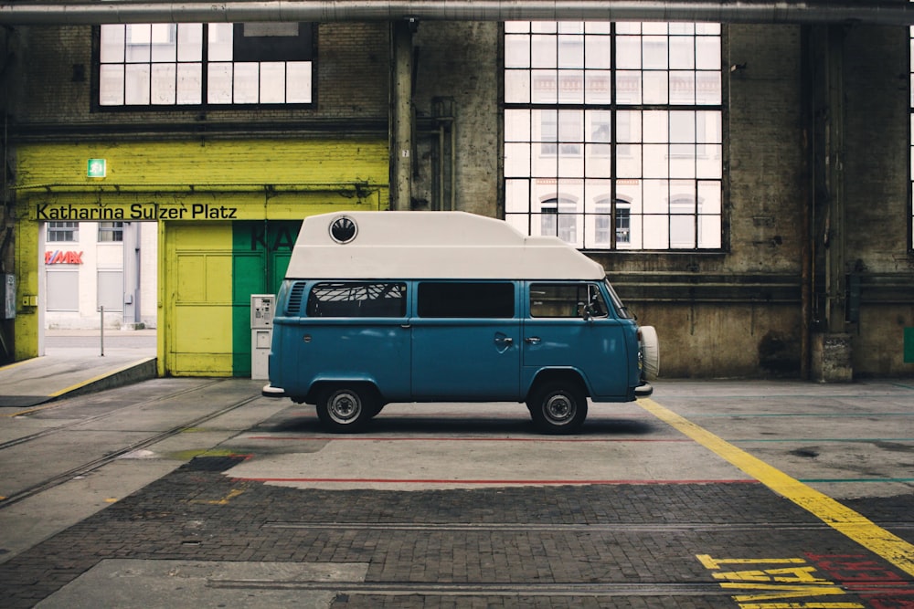 blue and white van inside yellow painted warehouse