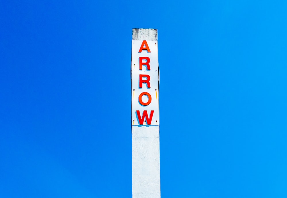 Arrow signage under blue sky