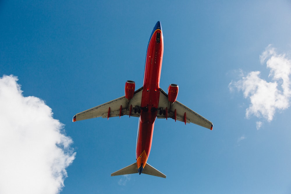 low-angle photography red and white plane