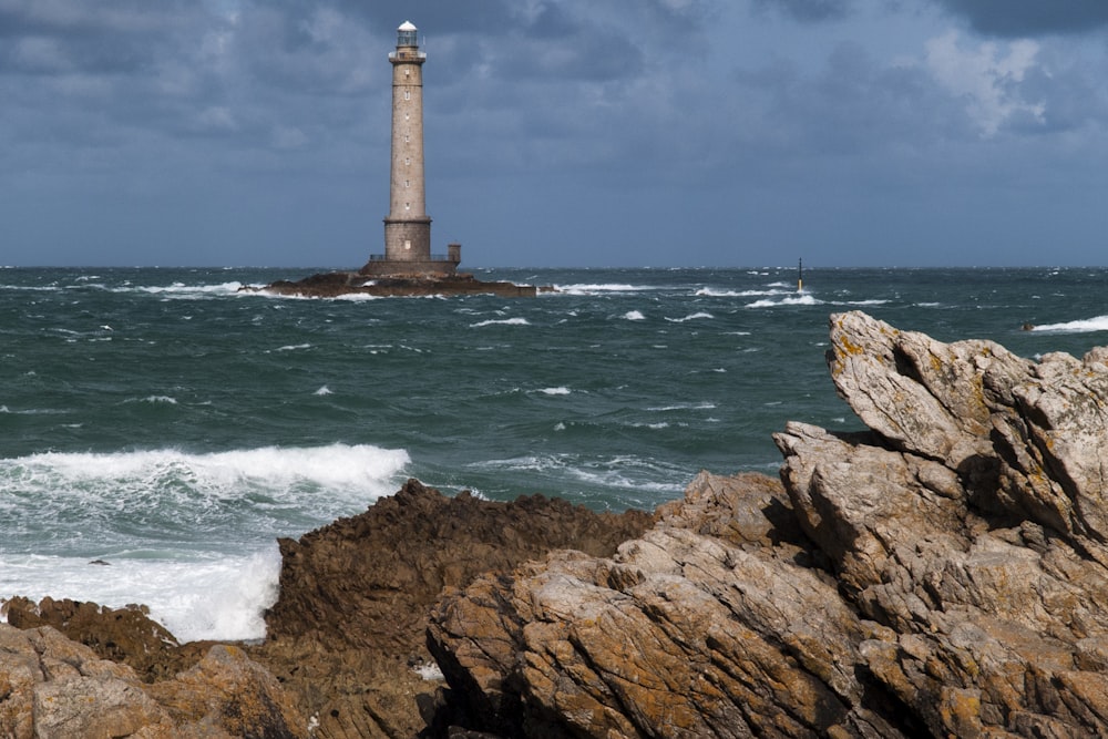 landscape photography of lighthouse near body of water