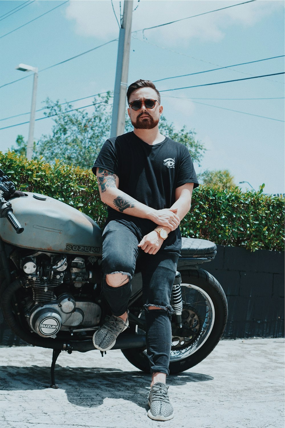 man beside Suzuki motorcycle