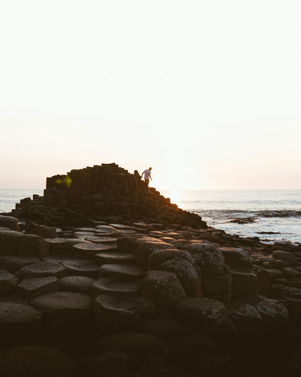 brown rock formation near body of water during daytime