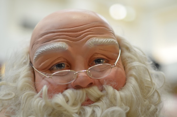 A close-up of a gentle, alien-like face with a mix of humor and melancholy in its eyes.