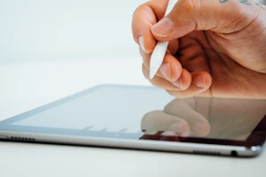 Close-up of hands interacting with a Microsoft Power Platform interface on a tablet.