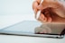 person holding white stylus pen