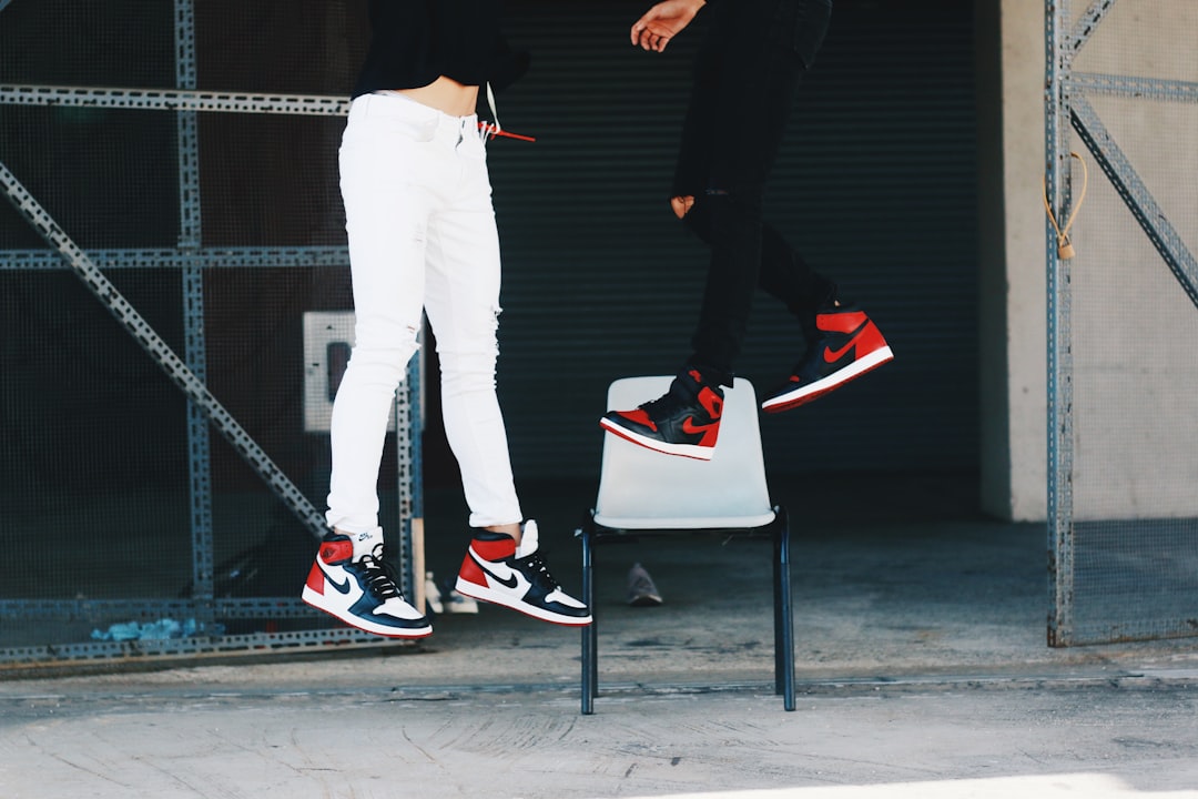 two people wearing Air Jordan shoes jumping