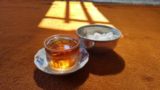 A warm, inviting workspace with a cup of tea and elegant Islamic accessories nearby.