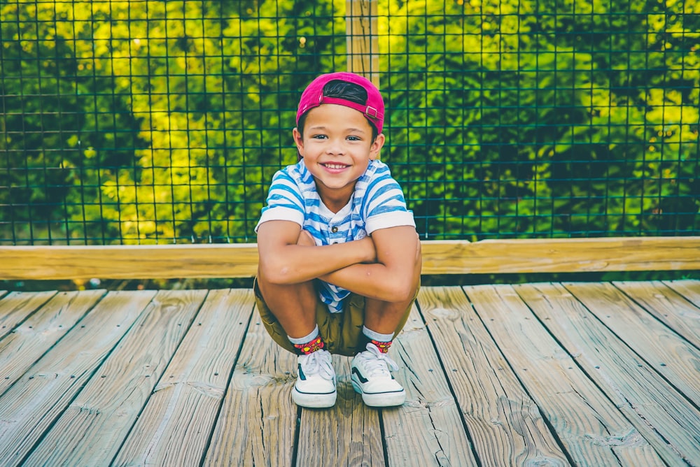 boy on wooden porch near railing