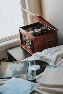 A beautifully crafted record player table in a cozy setting.