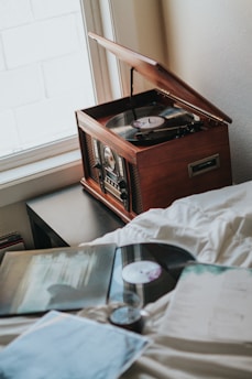A cozy vintage record player surrounded by Ruby Mae Davenport's vinyl albums and merchandise.