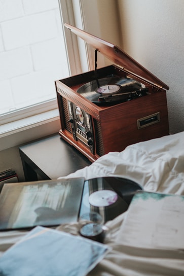 A cozy vintage record player surrounded by Ruby Mae Davenport's vinyl albums and merchandise.