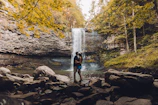 Couple admiring a breathtaking waterfall during their nature excursion
