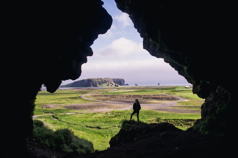 woman standing on rock formation during daytimr