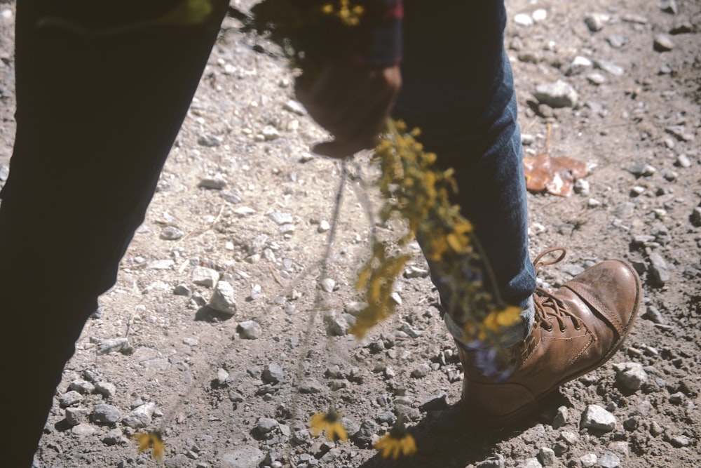 person walking while holding flowers