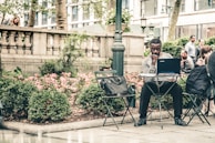 A peaceful park scene with women working on laptops outdoors, symbolizing remote work freedom.