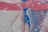 Fluid and abstract paint patterns blend together with layers of pink, white, blue, and purple creating a marbled effect. The image features swirling textures and a variety of circular shapes that appear to be bubbles or cells.