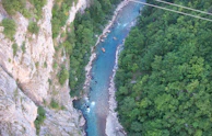 A panoramic view of the river winding through dense forest, perfect for an exciting rafting trip.