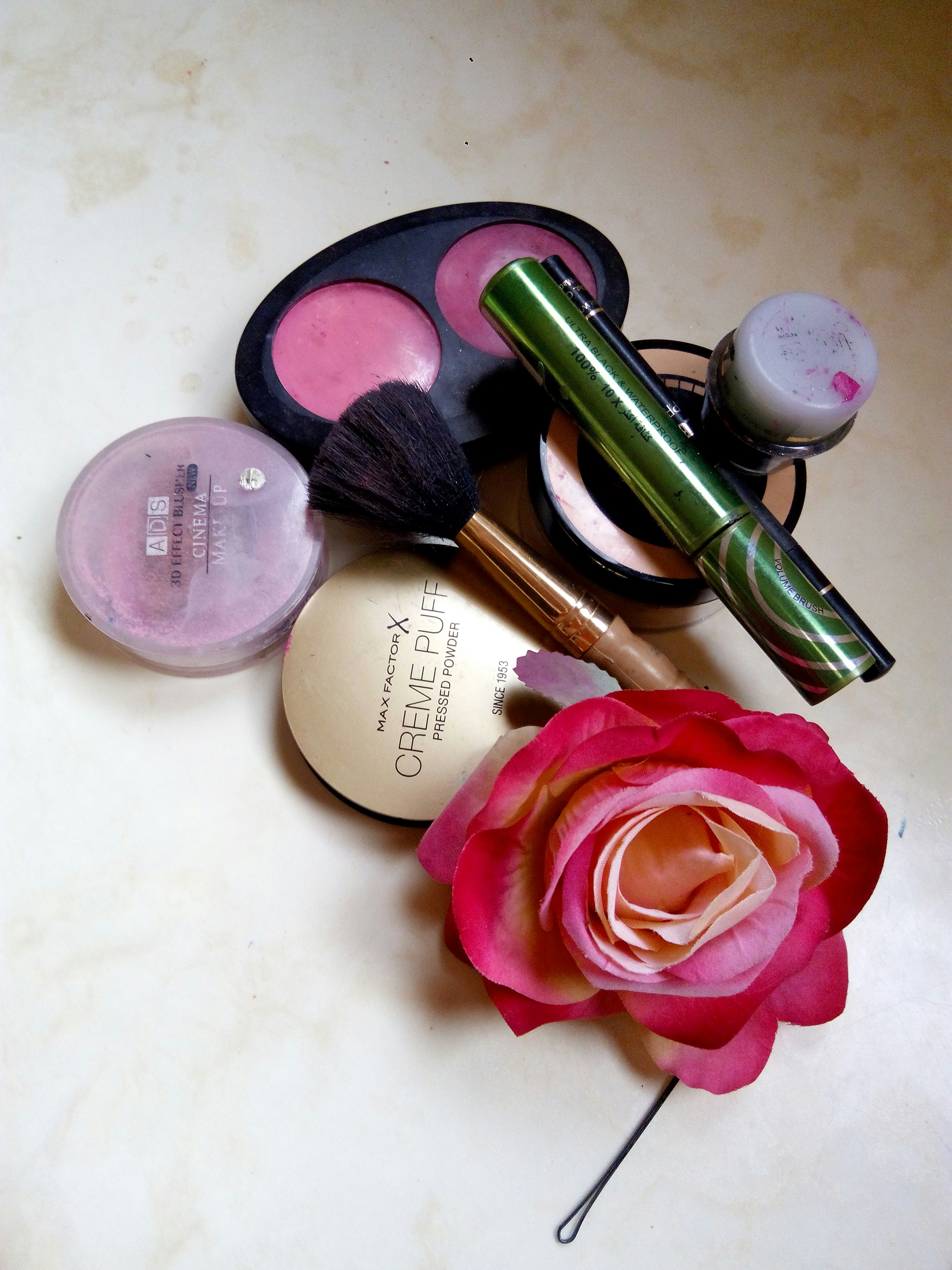 Blush compact with rosy pink powder on bright marble surface, elegant beauty product photography