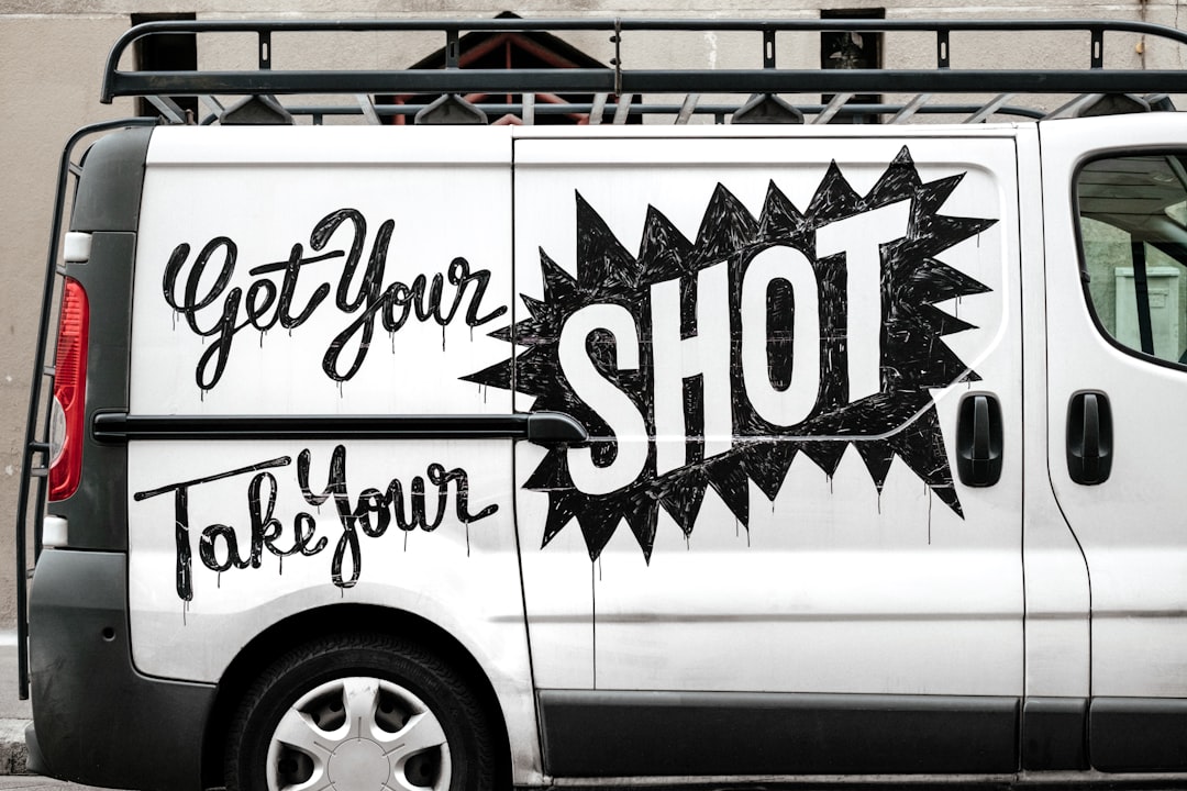 Graffiti on a white van that says "get your shot, take your shot"