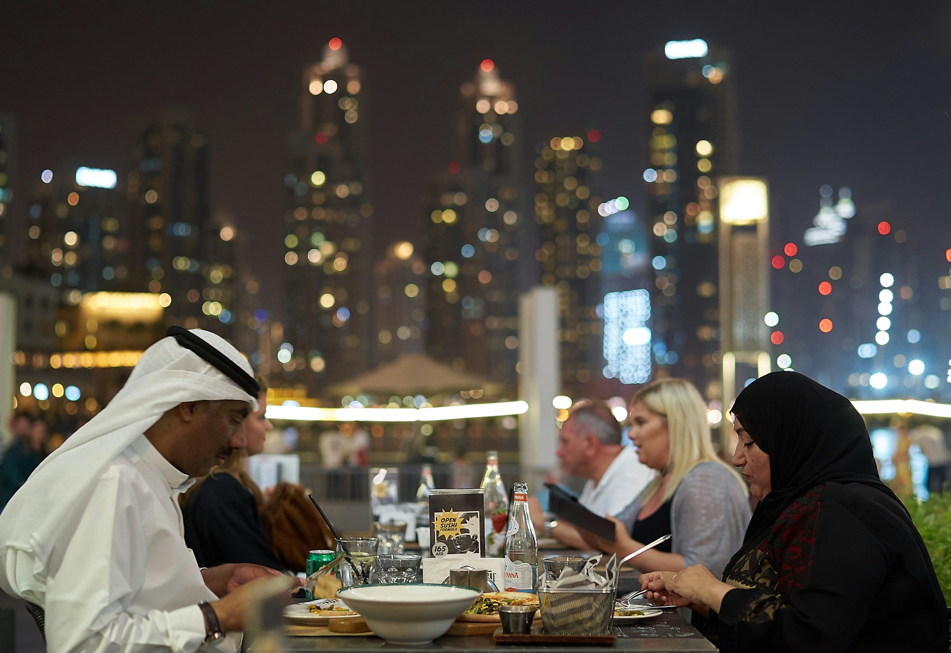 woman wearing yellow long-sleeved dress under white clouds and blue sky during daytime