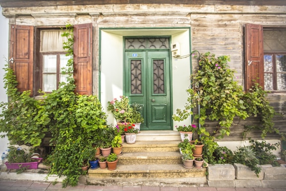 A welcoming front door of a vacation rental home surrounded by greenery.