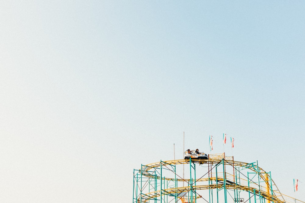 a roller coaster with people sitting on top of it