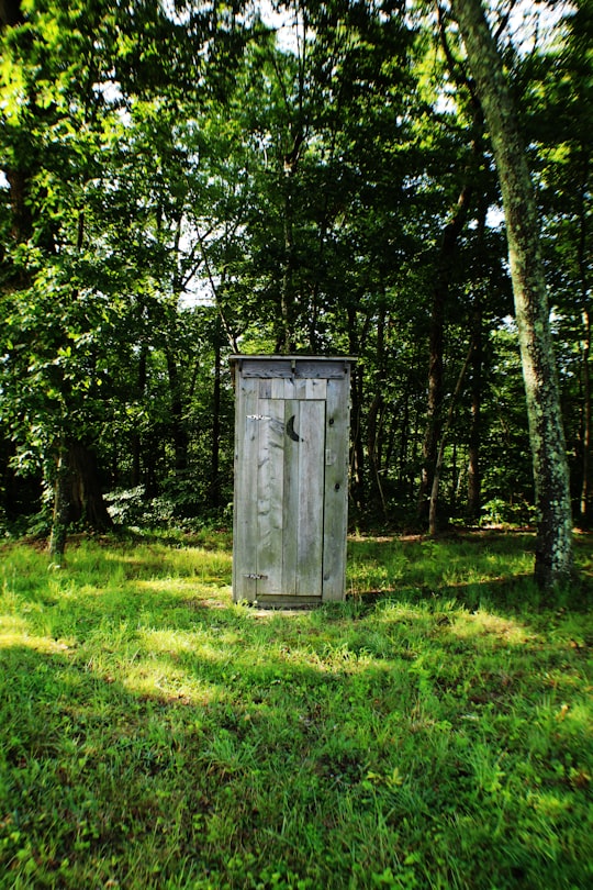 gray wooden outdoor portable bathroom in Kentucky United States
