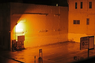 Well-lit, secure parking area with clear signage at Rusty Estate during dusk.