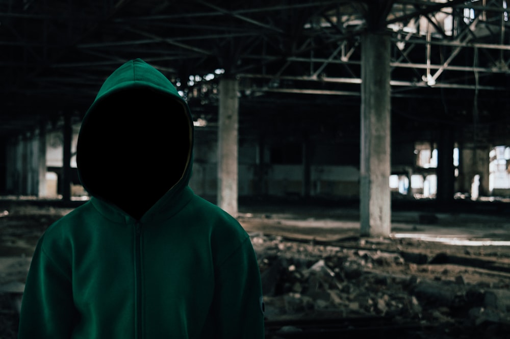 person wearing green hooded jacket