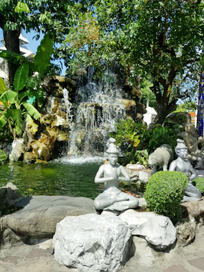 A peaceful moment of prayer by the water feature, reflecting the oasis theme.