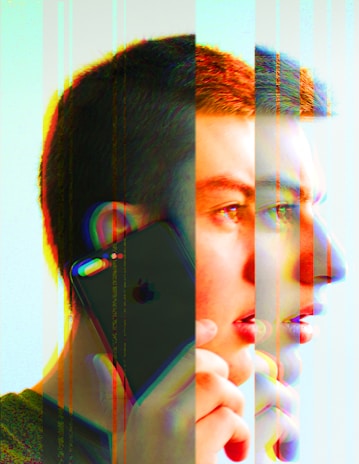 A young person with short hair is holding a smartphone to their ear, depicted with a creative glitch effect that multiplies and distorts their facial features and the phone. The image has a colorful overlay that creates a dynamic, abstract feel.